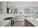 Bright kitchen with stainless steel appliances and quartz countertops and a window with natural light at 13737 Roderick Dr # 186, Huntersville, NC 28078