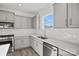 Modern kitchen featuring quartz countertops, gas range, and stainless steel appliances at 13737 Roderick Dr # 186, Huntersville, NC 28078
