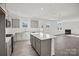Open concept kitchen with eat-in island, gas range, and stainless steel appliances at 13737 Roderick Dr # 186, Huntersville, NC 28078