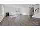 Spacious living room showcases a fireplace, staircase, laminate wood-look flooring, and abundant natural light at 13737 Roderick Dr # 186, Huntersville, NC 28078