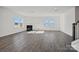 Spacious living room with fireplace, ample windows for natural light, and laminate wood-look flooring at 13737 Roderick Dr # 186, Huntersville, NC 28078