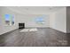 Living room features large windows, a gas fireplace, and laminate wood-look flooring at 13737 Roderick Dr # 186, Huntersville, NC 28078