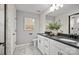 A luxurious bathroom showcases a dual sink vanity, black fixtures, and elegant marble-look tile flooring at 13752 Roderick Dr # 175, Huntersville, NC 28078