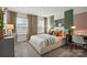 A modern bedroom includes carpeted flooring, a desk, and two windows for ample natural light at 13752 Roderick Dr # 175, Huntersville, NC 28078