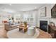 Bright living room with fireplace, modern decor, and seamless flow to dining area at 13752 Roderick Dr # 175, Huntersville, NC 28078