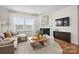 Cozy living room with a fireplace, large window, and comfortable seating arrangement at 13752 Roderick Dr # 175, Huntersville, NC 28078