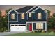 New construction two-story home showcasing navy blue siding, a red door, white trim, and a two car garage at 15019 Meadows Hunt Ln # 163, Huntersville, NC 28078