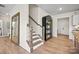 Inviting hallway with wood floors, a staircase, and decorative furnishings offering a warm welcome at 15019 Meadows Hunt Ln # 163, Huntersville, NC 28078