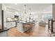 Open kitchen featuring a kitchen island with seating, stainless appliances, and views into the living area at 15019 Meadows Hunt Ln # 163, Huntersville, NC 28078