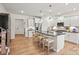Bright, open kitchen with center island, seating, stainless steel appliances, and modern white cabinets at 15019 Meadows Hunt Ln # 163, Huntersville, NC 28078
