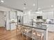 Well-lit kitchen boasts a center island with seating, stainless steel appliances, and white cabinets at 15019 Meadows Hunt Ln # 163, Huntersville, NC 28078