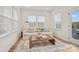 Cozy sunroom features comfortable seating, lots of windows, and access to the outdoor space at 15019 Meadows Hunt Ln # 163, Huntersville, NC 28078