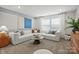 Comfortable living room with modern decor, featuring a large sectional sofa, soft lighting and stylish accents at 15019 Meadows Hunt Ln # 163, Huntersville, NC 28078