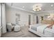 Bright main bedroom featuring tray ceiling, ensuite bath, walk-in closet, and sitting area at 15019 Meadows Hunt Ln # 163, Huntersville, NC 28078