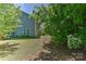 Expansive backyard featuring a lush lawn, mature trees, and a cozy patio area for outdoor enjoyment at 15035 Ockeechobee Ct, Mint Hill, NC 28227