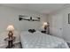Neutral bedroom featuring carpet, wall art, two lamps, and a comfortable bed with patterned bedding at 15035 Ockeechobee Ct, Mint Hill, NC 28227