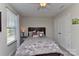 Cozy bedroom with a ceiling fan, bedside table, and lots of natural light at 15035 Ockeechobee Ct, Mint Hill, NC 28227