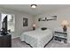 This bedroom offers a cozy space with comfortable carpeting, a window with blinds, and artistic wall decorations at 15035 Ockeechobee Ct, Mint Hill, NC 28227