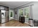 Bright breakfast nook features modern finishes, a window, stainless appliances, and an exterior door at 15035 Ockeechobee Ct, Mint Hill, NC 28227