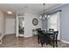 Open dining area with elegant lighting, hardwood floors, and views of an adjacent office at 15035 Ockeechobee Ct, Mint Hill, NC 28227