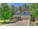 Charming two-story home with a manicured lawn, mature trees and a two-car garage at 15035 Ockeechobee Ct, Mint Hill, NC 28227