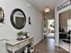 Inviting foyer featuring hardwood floors, decorative mirror, and a view into the home office at 15035 Ockeechobee Ct, Mint Hill, NC 28227