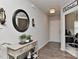 Inviting foyer featuring hardwood floors, decorative mirror, and a view into the home office at 15035 Ockeechobee Ct, Mint Hill, NC 28227