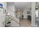 Inviting foyer with hardwood floors, staircase, and views into the dining room at 15035 Ockeechobee Ct, Mint Hill, NC 28227