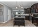 Well-equipped kitchen with dark cabinets, stainless steel appliances, a center island, and an open layout at 15035 Ockeechobee Ct, Mint Hill, NC 28227