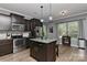 Updated kitchen featuring dark cabinets, stainless steel appliances, and a central island with bar stool seating at 15035 Ockeechobee Ct, Mint Hill, NC 28227