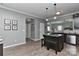 Open kitchen features dark cabinets, granite countertops, stainless appliances, and a kitchen island with seating at 15035 Ockeechobee Ct, Mint Hill, NC 28227
