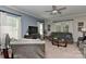 Spacious living room with a large TV, comfortable gray furniture, and natural light from multiple windows at 15035 Ockeechobee Ct, Mint Hill, NC 28227