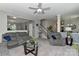 Cozy living room featuring comfortable gray furniture, a ceiling fan, and a view of the staircase at 15035 Ockeechobee Ct, Mint Hill, NC 28227