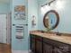 Charming bathroom featuring double vanity with granite countertops and oval mirror at 1669 Beleek Ridge Ln, Clover, SC 29710
