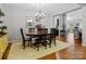 Open-concept dining room with wood table, chairs, and rug at 1669 Beleek Ridge Ln, Clover, SC 29710