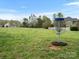 Disc golf basket on a lush green field with homes in the distance under a bright, sunny sky at 1669 Beleek Ridge Ln, Clover, SC 29710