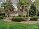 Stone entrance sign for Mill Creek Falls surrounded by manicured landscaping and palm trees at 1669 Beleek Ridge Ln, Clover, SC 29710