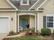 Inviting front entrance with a blue door, white pillars, and seating at 1669 Beleek Ridge Ln, Clover, SC 29710