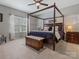 Inviting main bedroom features a four-poster bed, ceiling fan, and natural light at 1669 Beleek Ridge Ln, Clover, SC 29710