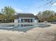 Outdoor pool, currently covered and surrounded by trees and a clubhouse at 1669 Beleek Ridge Ln, Clover, SC 29710