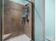 Modern shower with a glass door, tiled walls, and convenient corner shelf at 1669 Beleek Ridge Ln, Clover, SC 29710