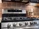 Close-up of a stainless steel GE Profile stove with tile backsplash at 1669 Beleek Ridge Ln, Clover, SC 29710