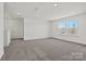 Spacious carpeted bedroom with large windows and double door closet, offering ample natural light at 18013 Aura Mist Way # 183, Huntersville, NC 28078