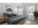 Relaxing bedroom showcasing neutral tones, a comfortable bed, and bright, sunlit windows at 18013 Aura Mist Way # 183, Huntersville, NC 28078