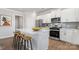 Modern kitchen features stainless steel appliances, an island with bar stools, and ample counter space at 18013 Aura Mist Way # 183, Huntersville, NC 28078