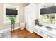 Bright bathroom featuring hardwood floors, storage, and natural light from two windows at 206 23Rd Nw St, Hickory, NC 28601