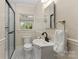 Bathroom featuring a tiled shower, white vanity and sink, and black and white tiled floor at 206 23Rd Nw St, Hickory, NC 28601