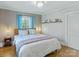 Comfortable bedroom features hardwood floors, a large window, and soft, neutral colors at 206 23Rd Nw St, Hickory, NC 28601