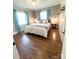 Cozy bedroom features hardwood floors, neutral walls, and light blue curtains at 206 23Rd Nw St, Hickory, NC 28601