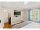 Cozy bedroom featuring hardwood floors, a mounted television, and natural light from a large window at 206 23Rd Nw St, Hickory, NC 28601